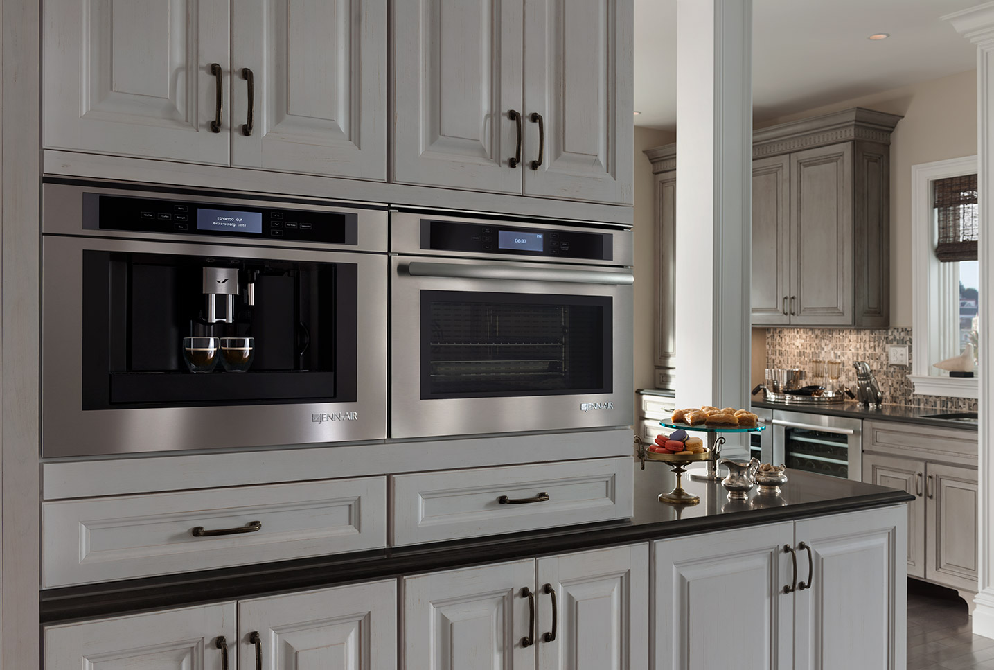 Built-in JennAir RISE stainless steel wall oven integrated into modern kitchen cabinetry
