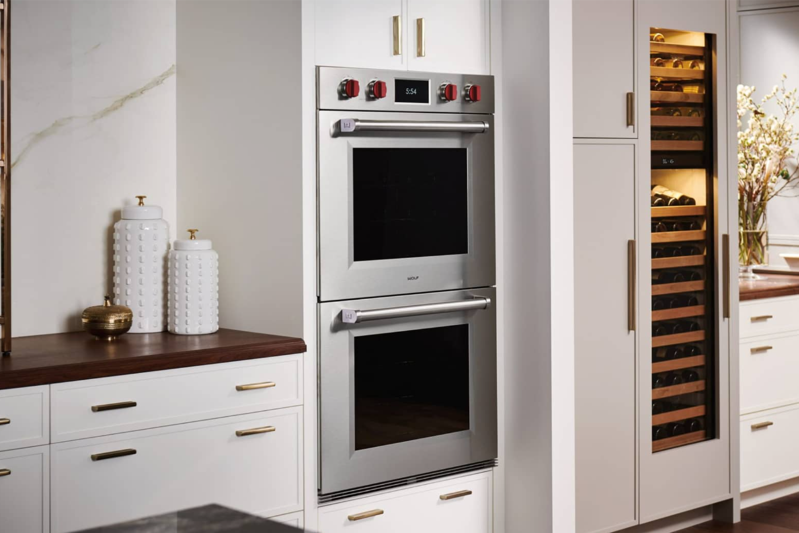 Built-in Wolf M Series stainless steel wall oven integrated into modern kitchen cabinetry